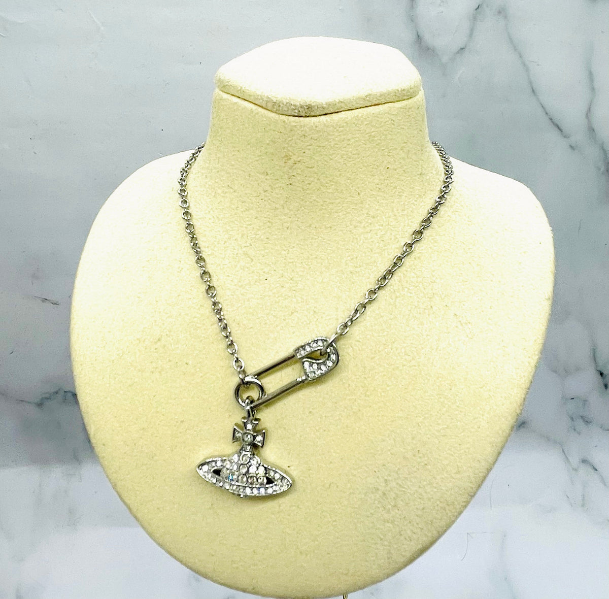Separate catalogue example, not the screen piece: VIVIENNE WESTWOOD Rhinestone Safety Pin Orb Necklace - Pre-Owned