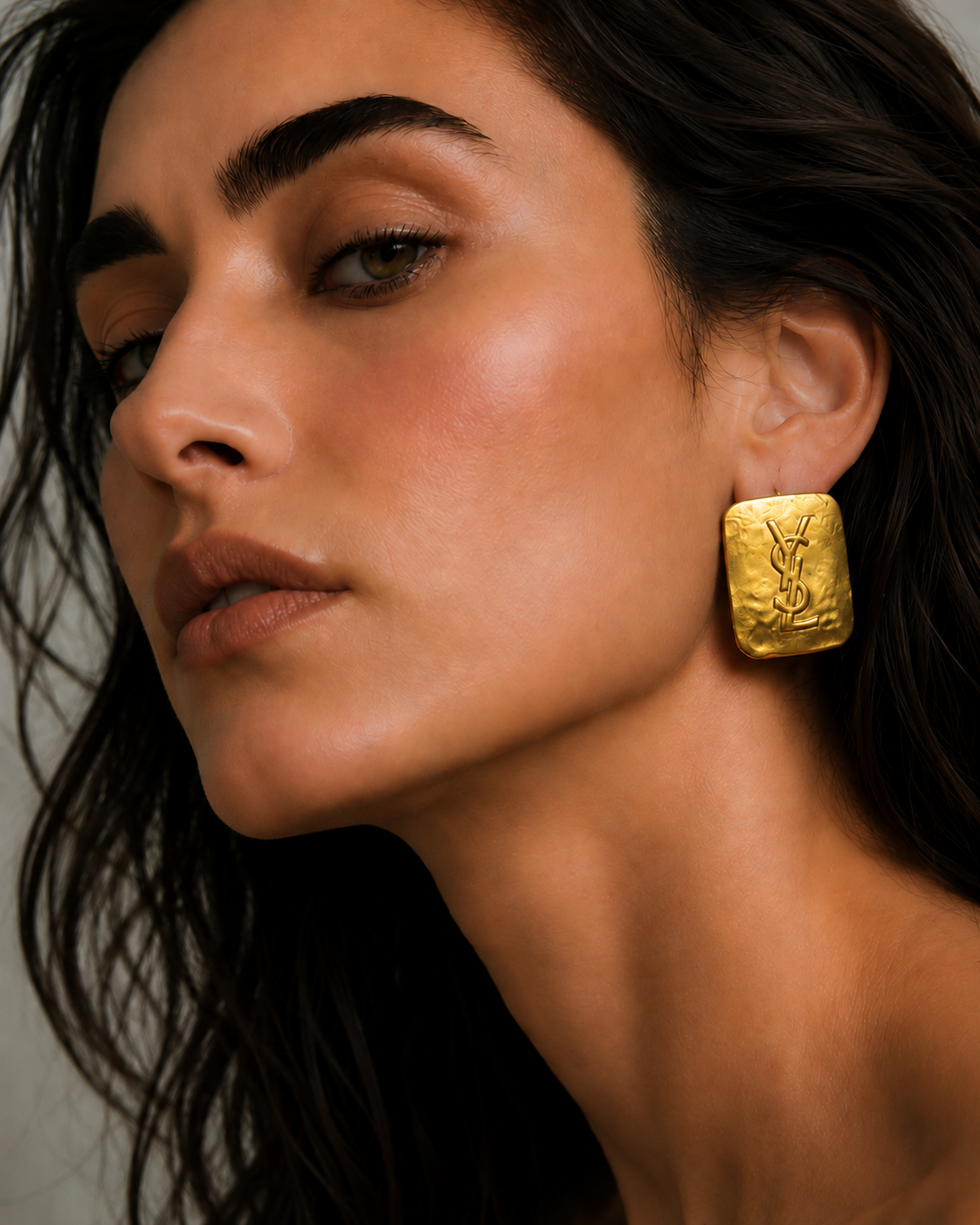 Rita wearing gold YSL earrings