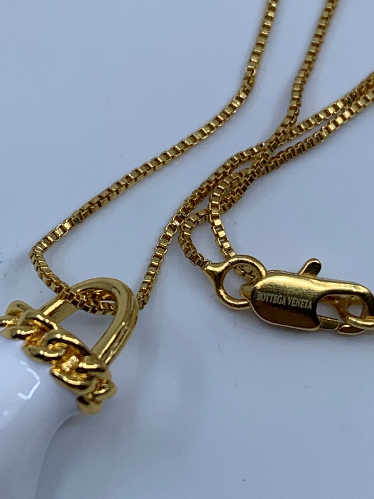 BOTTEGA VENETA Gold Tone & Porcelain Hand Charm with Fringe Necklace