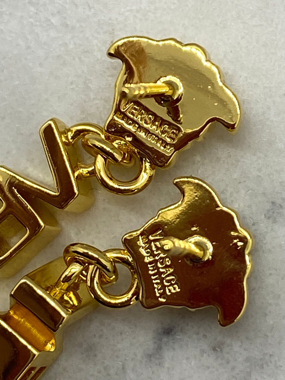 VERSACE Gold Tone Monogram Pendant Earrings - Pre owned