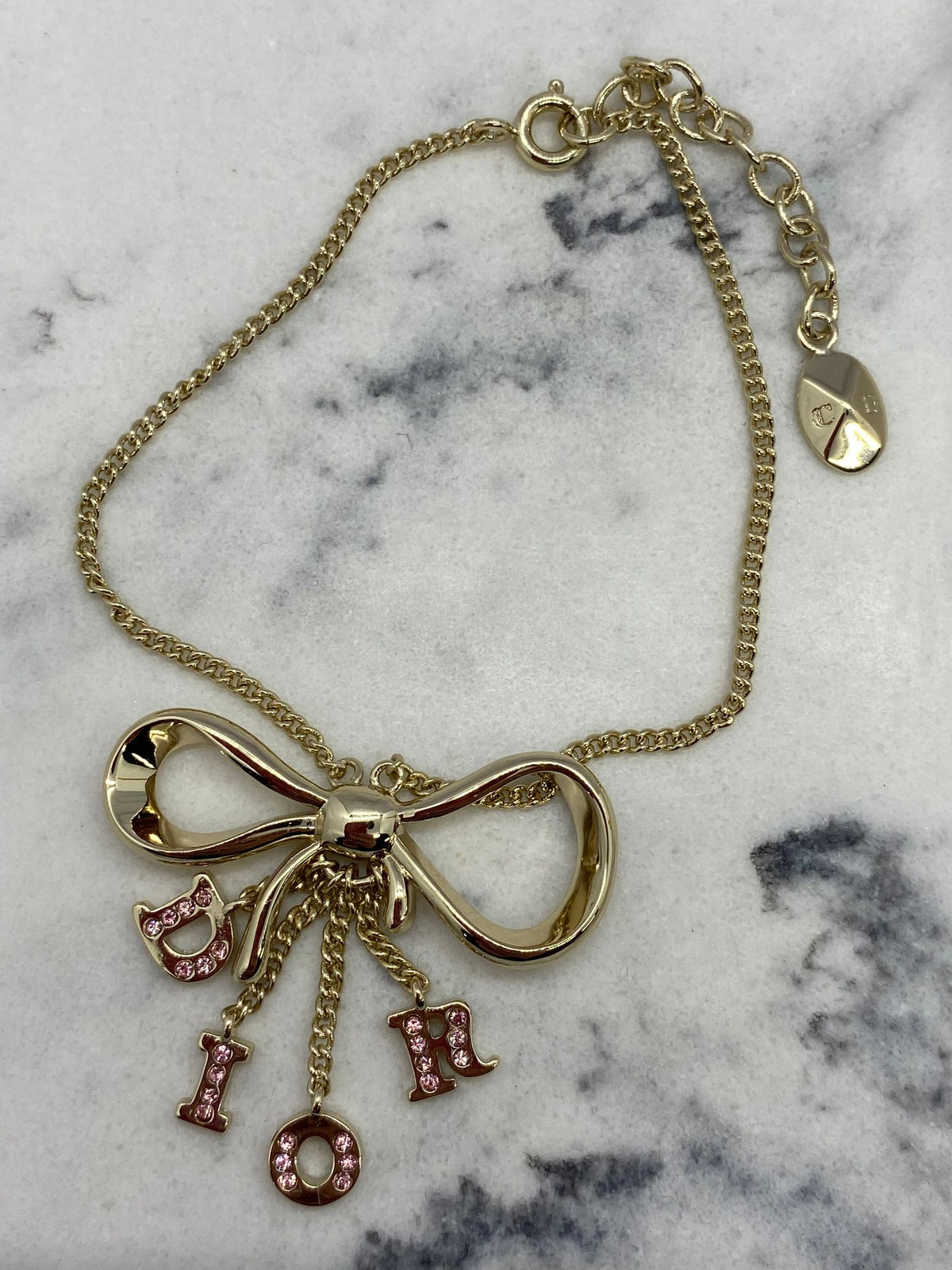 CHRISTIAN DIOR Silver Tone Ribbon Charm Bracelet - USED